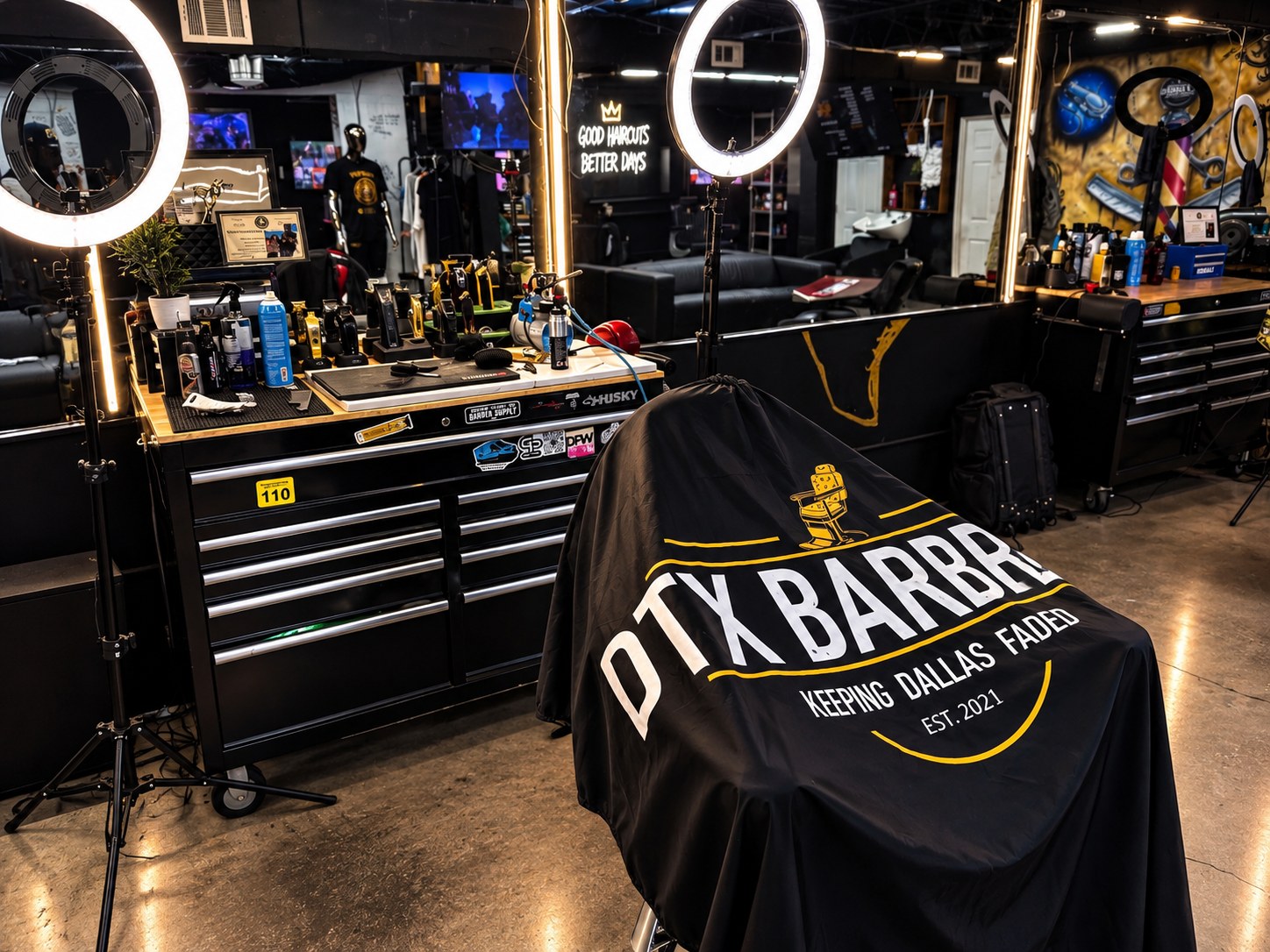 A branded DTX cape on a chair between mirror-lit stations